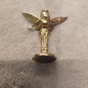 Golden Tinker Bell token from the 2009 Monopoly Disney Edition board game.
